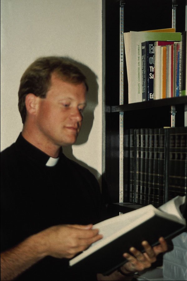 690015 Clergyman In Library A4 Photo Print