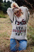 690022 Girl With Jeans And Sweater Kneeling In Grass A4 Photo Print
