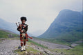 690065 Piper In Glencoe, Scotland A4 Photo Print
