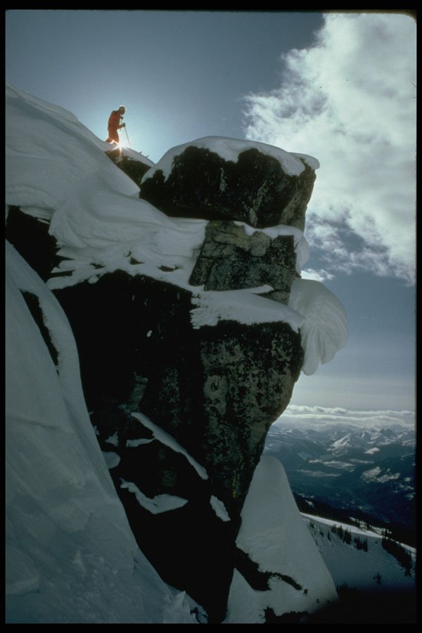 697020 Lone Snow Skier On Top Of Large Rock Edge A4 Photo Print