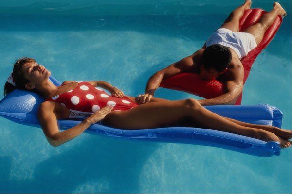 702050 Maria And Martin Lying On White Loungers In Pool A4 Photo Print
