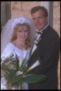 702084 Bride And Groom In Front Of Golden Brick Building A4 Photo Print