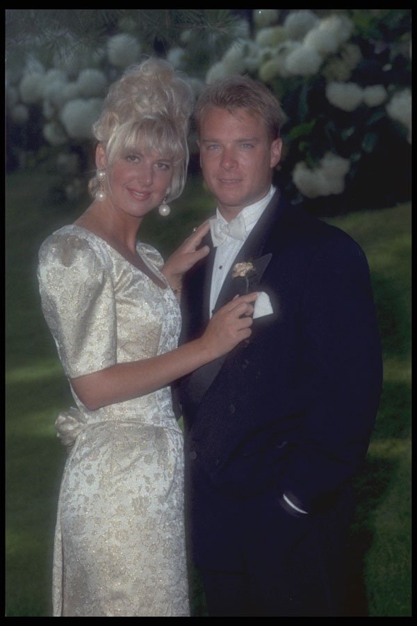 702089 Bride Holding Onto Groom's Lapel A4 Photo Print