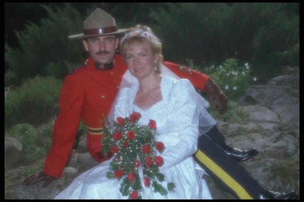 702096 Bride And Groom In A Mountie Uniform Sitting On A Rock A4 Photo Print