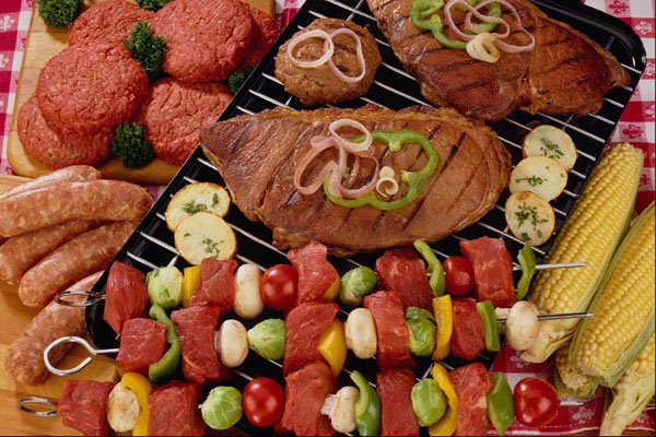 710060 Barbecue With Uncooked And Cooked Meat On The Grill A4 Photo Print
