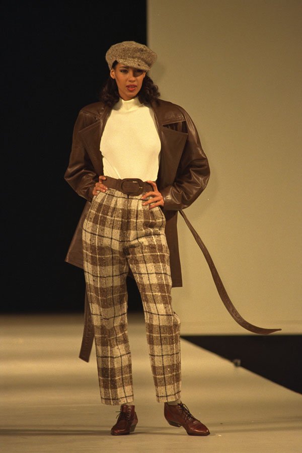 712034 Woman Wearing Brown Tartan Trousers, Leather Coat And Cap A4 Photo Print