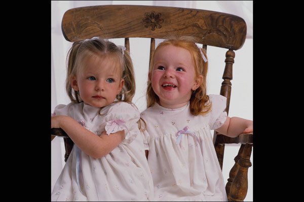 716031 Twin Girls Sitting On A Chair Together A4 Photo Print