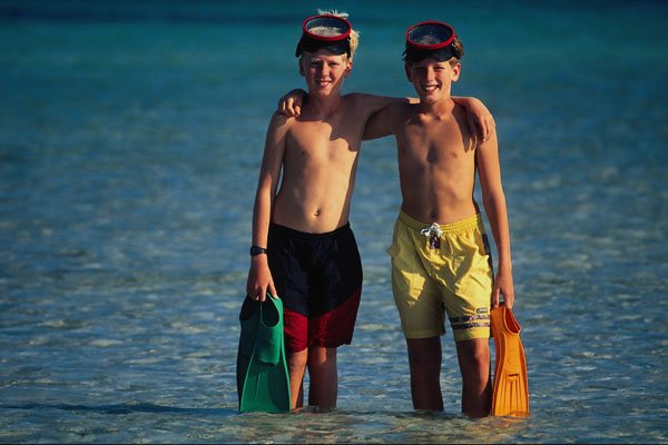 716045 Two Young Boys In Sea With Masks And Flippers A4 Photo Print