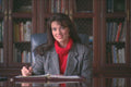 719005 A Professional Woman Sitting At Executive Desk, Smiling A4 Photo Print