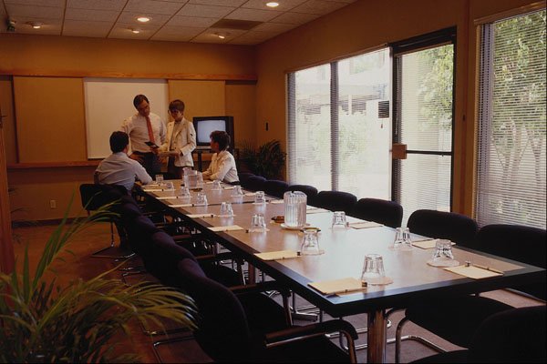 719045 Executives In Small Conference Room A4 Photo Print