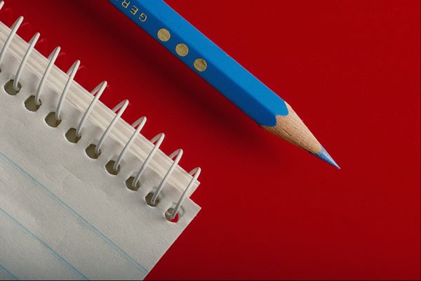 719068 Blue Pencil And Notepad On Red Background A4 Photo Print