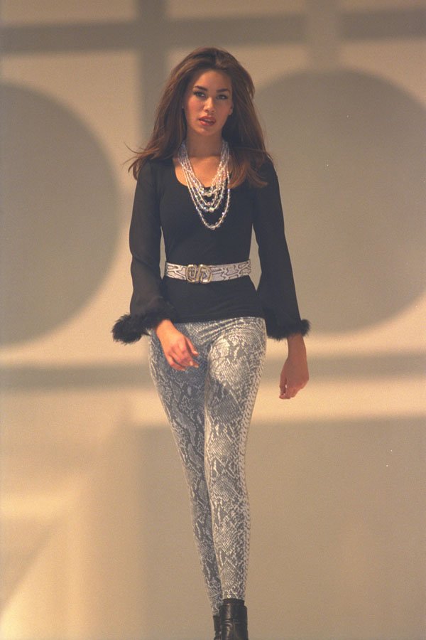 725060 Female Wearing Gray Patterned Leggings And Belt, Black Top A4 Photo Print