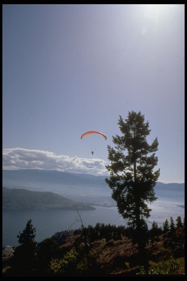 735001 Paraglider Flying Over Valley Lake A4 Photo Print