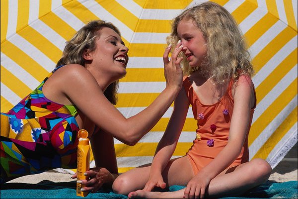 745079 Woman Applying Sun Lotion On Child A4 Photo Print