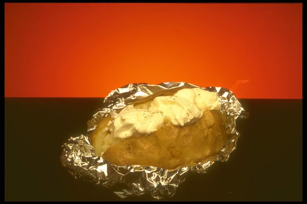 757008 Baked Potato With Sour Cream, Against Orange Background A4 Photo Print