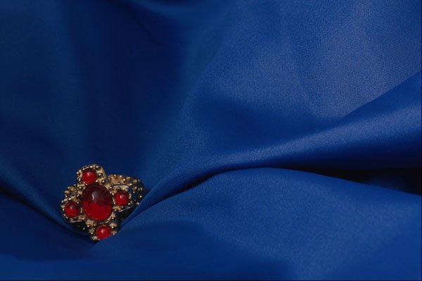 762097 Red Ring On Blue Material A4 Photo Print
