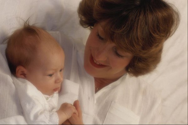 767074 Mother With Very Young Baby In Bed A4 Photo Print