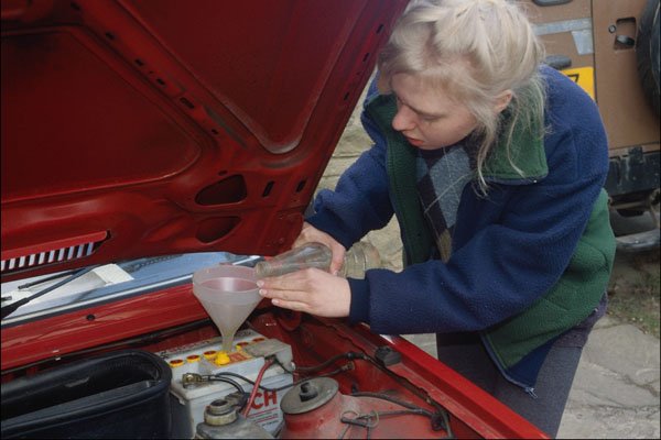 769065 Teenager Topping Up Car Battery A4 Photo Print