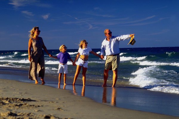 770050 Family Of Four, On Beach A4 Photo Print