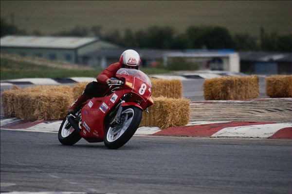 779098 Red Motorcycle Racing On Racetrack A4 Photo Print