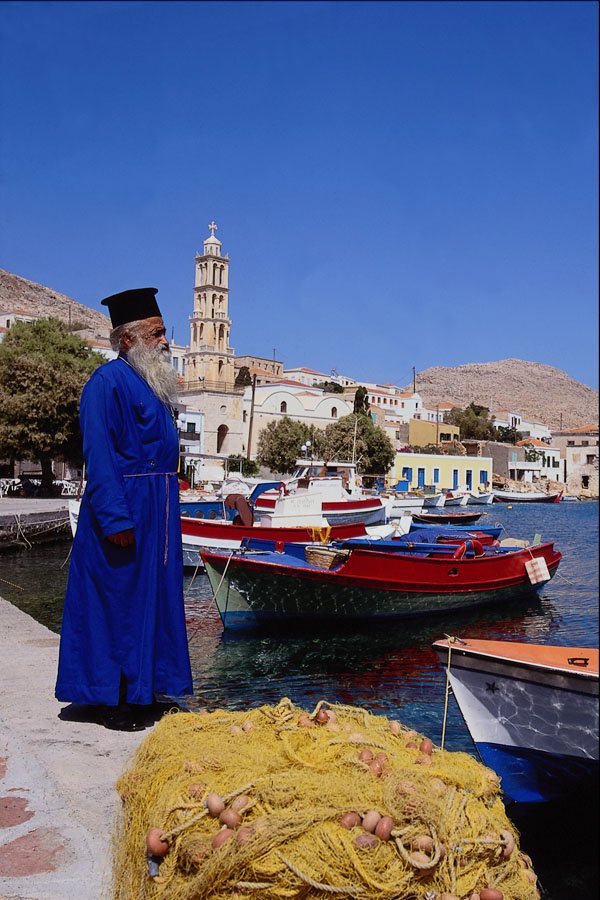 783026 Priest At Harbor, Halki, Greece A4 Photo Print