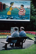 784031 Elderly Couple Sitting On Bench, With Poster, Morecombe A4 Photo Print