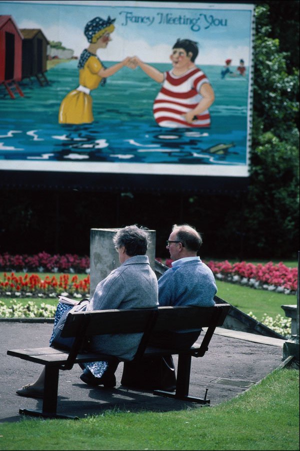 784031 Elderly Couple Sitting On Bench, With Poster, Morecombe A4 Photo Print