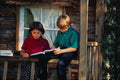 784058 Girl And Boy Reading On Rustic Porch A4 Photo Print